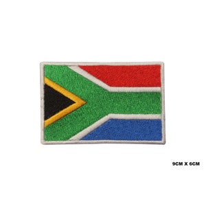 May include: Embroidered South African flag patch with the colors green, yellow, black, red, white, and blue. The patch measures 9 cm by 6 cm.