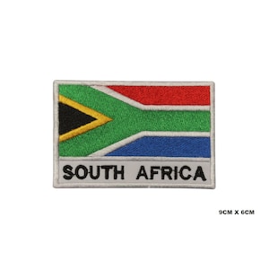 May include: Embroidered iron-on patch featuring the South African flag with the words "SOUTH AFRICA" below. The flag is green, yellow, black, red, and blue. The patch is 9 inches by 6 inches.