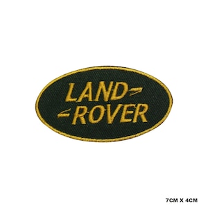 May include: Green oval embroidered patch with the text "LAND-ROVER" in gold thread. The patch measures 7 cm by 4 cm.