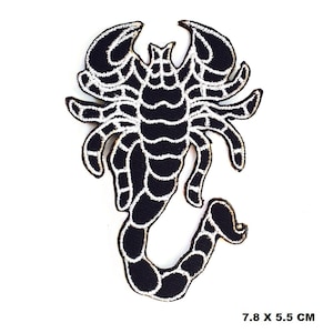 May include: Black and white embroidered scorpion patch with a white outline. The patch is 7.8 x 5.5 cm.