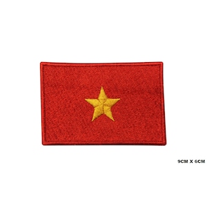 May include: Red embroidered patch with a yellow five-pointed star in the center. The patch measures 9 inches by 6 inches.