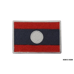 May include: Embroidered patch of the Laotian flag. The flag is red with a blue band in the center and a white circle in the blue band. The patch is 9 cm by 6 cm.