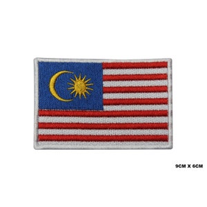 May include: An embroidered patch of the Malaysian flag. The flag is red and white with a blue canton featuring a yellow crescent moon and a 14-pointed star. The patch is 9 cm by 6 cm.