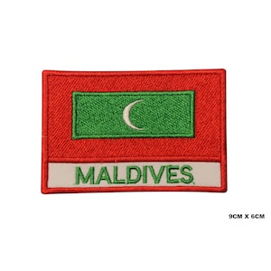 May include: An embroidered patch featuring the flag of the Maldives. The patch is red with a green rectangle in the center containing a white crescent moon. The words "MALDIVES" are written in white below the flag.
