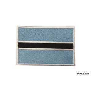 May include: An embroidered patch of the flag of Botswana. The flag is light blue with a black horizontal stripe in the center. The patch is 9 cm by 6 cm.