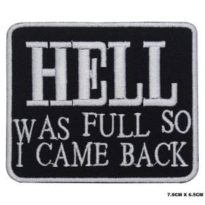 May include: Black and white embroidered patch with the text "HELL WAS FULL SO I CAME BACK" in a white font on a black background. The patch is 7.9 cm by 6.5 cm.