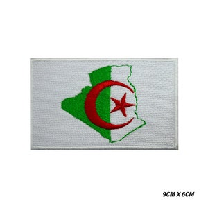 May include: A white embroidered patch with the outline of Algeria in green, a red crescent moon and a white star. The patch measures 9 inches by 6 inches.