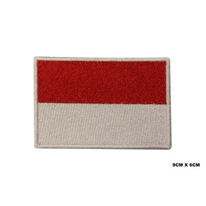May include: Red and white embroidered patch of the Indonesian flag. The patch is 9 inches by 6 inches.