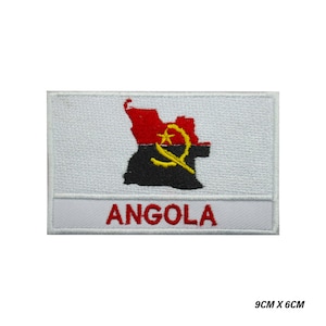 May include: White embroidered patch with the Angolan flag, featuring a red, black, and yellow map of Angola with a yellow star and a red and yellow symbol. The text "ANGOLA" is embroidered in red below the flag.