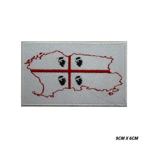 May include: White embroidered patch with a red outline of the island of Sardinia and a red cross with four black Moor's heads. The patch measures 9 cm by 6 cm.
