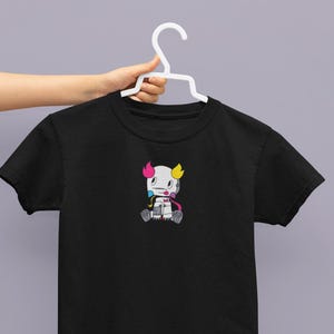 May include: Black t-shirt with a cartoon character wearing a pink, blue, and yellow hat. The character has a white body and is holding a paintbrush.