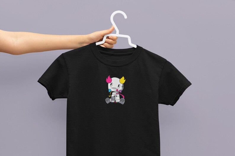 May include: Black t-shirt with a cartoon character wearing a pink, blue, and yellow hat. The character has a white body and is holding a paintbrush.
