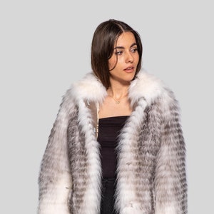 Modern fox fur jacket in black cross color, cozy and elegant winter coat.
