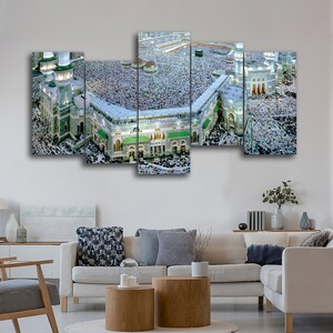 May include: A multi-panel canvas print depicting an aerial view of a large mosque with a crowd of people gathered in the courtyard. The mosque has a white exterior with green accents and multiple minarets.