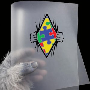 May include: A transparent sheet with a colorful puzzle piece design. The design features a diamond shape with a puzzle piece in the center, and hands tearing open the sheet. The puzzle pieces are in red, green, blue, and yellow.