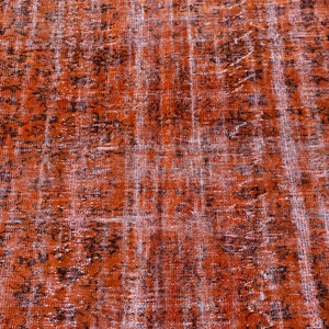 May include: A vintage rug with a distressed, faded look. The rug has a brown and white color scheme with a subtle pattern.