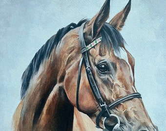 May include: A watercolor painting of a brown horse with a black mane and tail. The horse is wearing a bridle with a pink and green patterned band. The horse's head is turned to the side, and its eyes are closed. The painting is signed "Caroline Cook" in the bottom left corner and "ENABLE" in the bottom right corner.