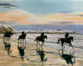 May include: A watercolor painting of four riders on horseback galloping along a sandy beach with a snowy shoreline in the background. The sky is a soft blue with a hint of pink and orange in the distance.