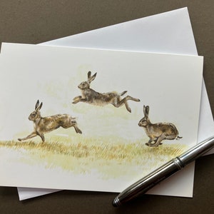 "Laufende Hasen Kunst Grußkarte ""Haring Entlang"" Blanko Karte von Braune Hasen."