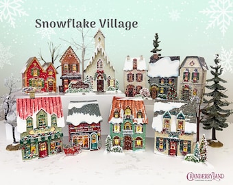 May include: A collection of miniature buildings labelled Snowflake Village, featuring various architectural styles with snow-covered roofs, festive holiday decorations, and illuminated windows. The set includes shops, a church, and houses.