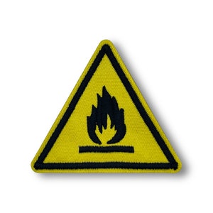 May include: Yellow triangle warning sign with a black border and a black flame symbol inside. The symbol depicts a flame with a horizontal line underneath.
