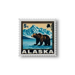 May include: A vintage 5 cent postage stamp featuring a brown bear walking on ice in front of a mountain range. The stamp is blue, white, and yellow with the word "ALASKA" printed at the bottom.