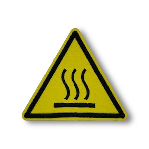 May include: Yellow triangle warning sign with a black border and a black symbol of three wavy lines above a horizontal line. The symbol indicates a hot surface.