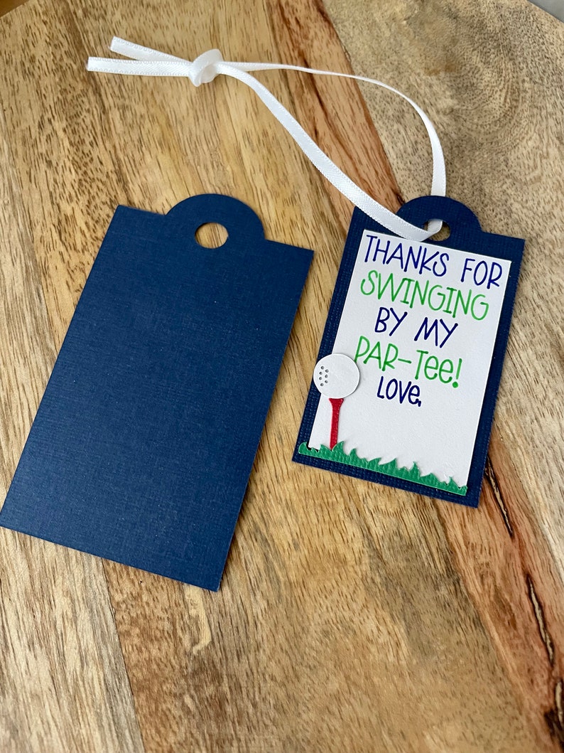 May include: A blue and white gift tag with the text "Thanks for swinging by my par-tee! Love." and a golf ball and tee graphic.