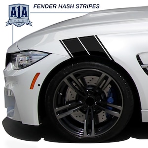 May include: White car fender with black hash stripes and the text "FENDER HASH STRIPES". The car has a black wheel with a silver rim and a blue brake caliper. The logo "A1A SALES" is in the upper left corner.