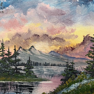 May include: An oil painting depicting a mountain lake scene with evergreen trees. The sky is filled with pink, yellow, and blue clouds. The painting is signed "Dal" with the date 11/9/59 and the number 26-12.