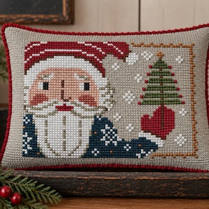 Patrón de punto de cruz en PDF de arte popular primitivo de Papá Noel patriótico, con un simpático rostro vintage, traje rojo, blanco y azul, además de un árbol. Por Acadia Stitchery.
