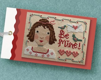 Seja minha!, um padrão de ponto cruz em PDF com um design para o Dia dos Namorados apresentando uma garota em estilo vintage, corações e um pássaro, em estilo primitivo e arte folclórica, da Acadia Stitchery.
