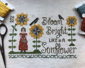 Padrão de ponto cruz em PDF de arte folclórica primitiva "Menina radiante com girassóis" da Acadia Stitchery.