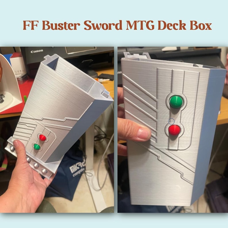 May include: A silver-colored deck box with a design inspired by the Buster Sword from Final Fantasy. The box features red and green button-like details and the text "FF Buster Sword MTG Deck Box".