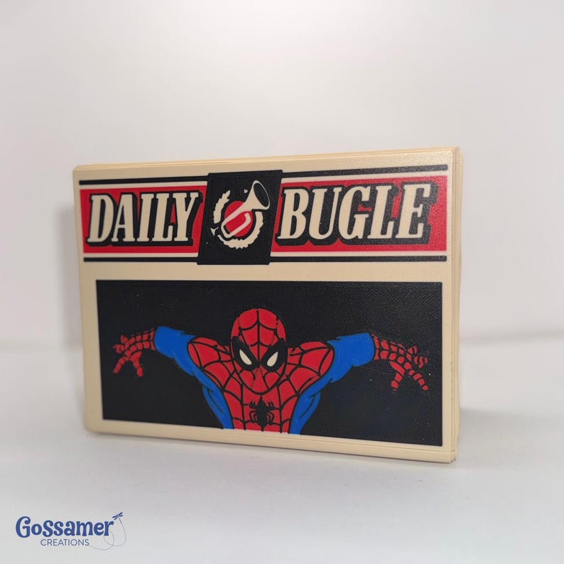 May include: A rectangular, off-white Daily Bugle sign featuring a red and black logo with the words "DAILY BUGLE" in white. Below, a black background showcases a red and blue Spider-Man graphic.