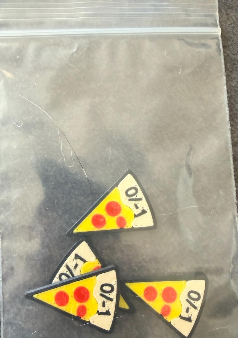 May include: Four triangular pizza slice charms with yellow cheese, red pepperoni circles, and a cream-colored crust edge. Each slice features the black text 0/1 printed on the crust. The charms are contained within a clear plastic zip-top bag.