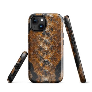 May include: A protective phone case featuring a textured, abstract pattern of deep amber, copper, and black tones. The design includes a circular MagSafe alignment ring visible on the back, with cutouts for the camera lens and side buttons.