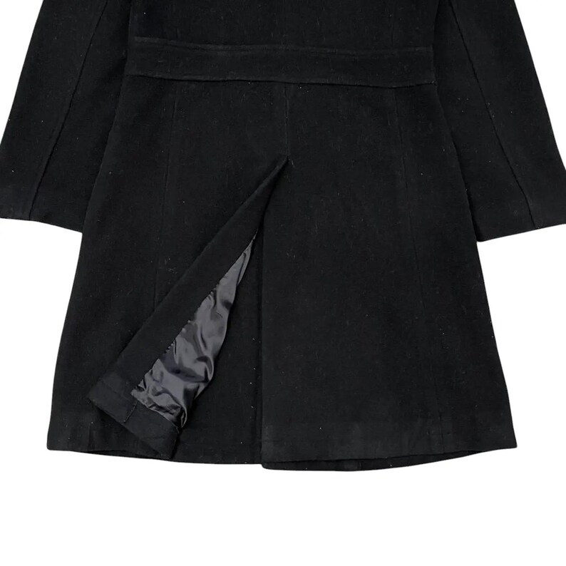 May include: A black coat with a tailored design. The coat features a notched collar, a belt detail at the waist, and a split at the hem. The interior lining is visible through the split.
