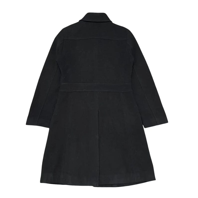 May include: A black coat with a collar, two front pockets, and a belt detail at the waist. The coat has long sleeves and a knee-length hem. The back of the coat is visible in the image.
