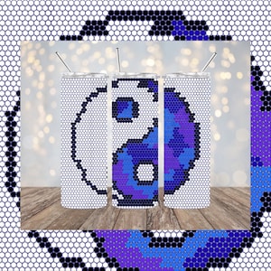 May include: Three stainless steel tumblers featuring a yin yang design. The design is made up of blue, purple and white hexagons. The tumblers are on a wooden surface.