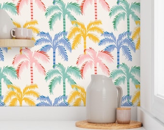 May include: A colorful wallpaper design featuring a repeating pattern of stylized palm trees in shades of pink, blue, yellow, and green against a cream background. The image also shows a white pitcher, a small cup, and a wooden coaster.