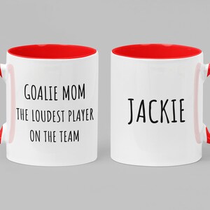 May include: Two white ceramic mugs with red handles and red interior rims. One mug says "Goalie Mom The Loudest Player On The Team" and the other mug says "Jackie".