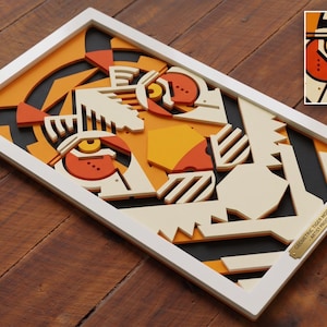 May include: A rectangular framed wall art piece featuring a layered geometric tiger face design in shades of orange, cream, black, and yellow. A small gold plaque in the corner reads GEOMETRIC TIGER MOCKUP - ARTIST PROOF. Includes a detailed thumbnail.