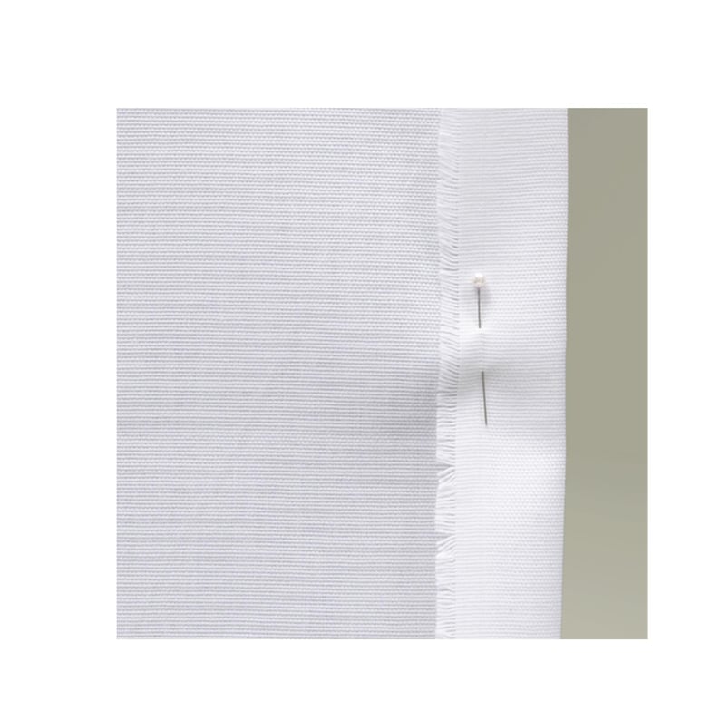 May include: A piece of solid white fabric with a visible woven texture. The right edge of the fabric is folded over, creating a hemmed appearance with a frayed, raw edge visible along the fold. Two straight sewing pins are inserted vertically.