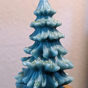 Festive Pine Tree candle with assorted colors and scents. Brighten up your home & holidays with these beautiful candles.