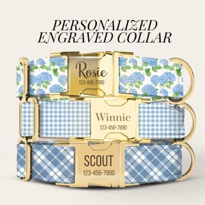 May include: Three personalized pet collars with gold-tone metal buckles engraved with names and phone numbers. The top collar features a blue hydrangea pattern, the middle has a light blue gingham check, and the bottom has a blue plaid design.
