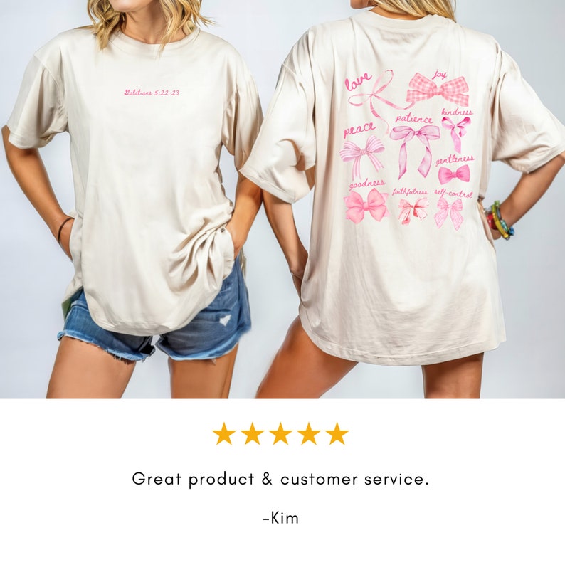 May include: Beige t-shirt with pink text and bow designs. The front of the shirt has the text "Galatians 5:22-23". The back of the shirt features the words "love, peace, joy, kindness, goodness, patience, gentleness, faithfulness, self-control" with bow illustrations.