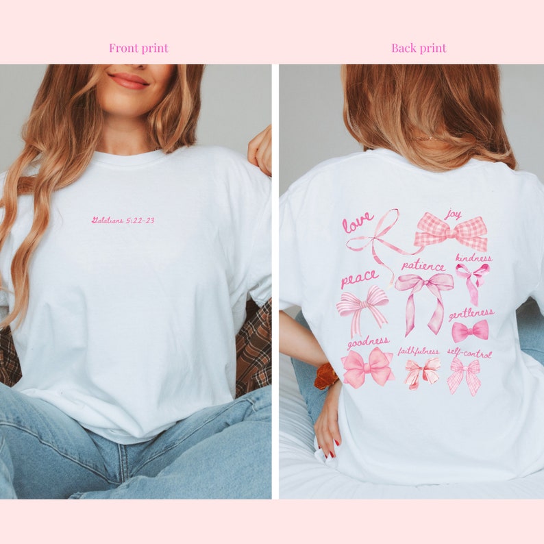 May include: White t-shirt with pink text and bow designs. The front has "Galatians 5:22-23" in pink script. The back shows pink bows with words such as "love," "peace," and "joy."