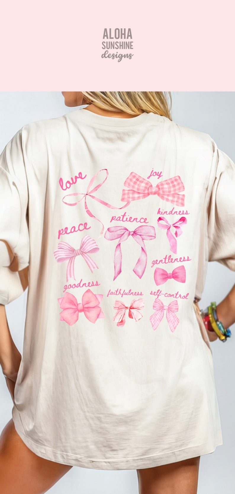 May include: A cream-coloured t-shirt featuring a pink bow design and inspirational words such as "love", "peace", and "joy". The shirt has a watercolour style with the text "Aloha Sunshine Designs" at the top.