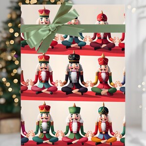 May include: A wrapped gift box featuring a repeating pattern of cartoon nutcrackers in various colors, seated in a meditative pose. The box is tied with a green satin ribbon and bow, perfect for holiday gift-giving.